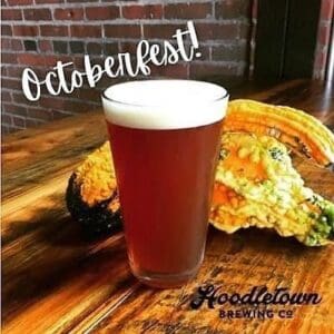 Pint of Hoodletown's Octoberfest beer with gourds in the background.